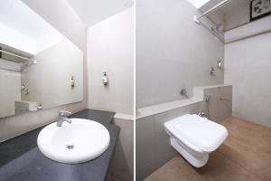 a bathroom with a white toilet and a sink at Townhouse Gandhi Medical College Bhopal Formerly Hotel Shagun in Bhopal
