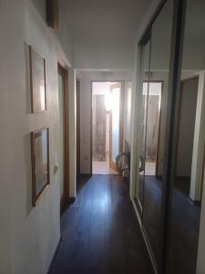 an empty room with a hallway with a mirror at SsaZza in Râmnicu Vâlcea