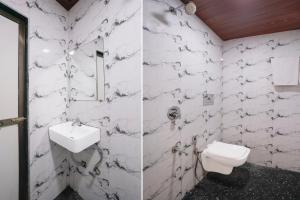 a white bathroom with a sink and a toilet at Collection O IIM Mumbai Formerly Green View in Mumbai