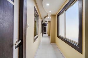 a hallway in a hospital with a window at Townhouse Bihar Sharif Formerly Amulya Inn in Bihār Sharīf