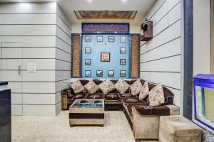 a living room with couches and a blue wall at Townhouse Bihar Sharif Formerly Amulya Inn in Bihār Sharīf