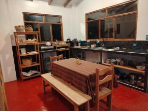 a kitchen with a table and chairs and a counter at Sami Huaypo Cabin in Cheqquerec