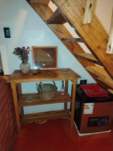 a wooden table with a mirror on top of a stairs at Sami Huaypo Cabin in Cheqquerec