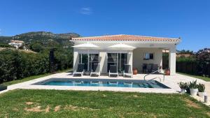a villa with a swimming pool and a house at Marilena in Skala