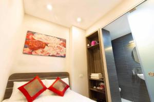a small bedroom with a bed and a shower at Bach Khoa Hotel in Hanoi