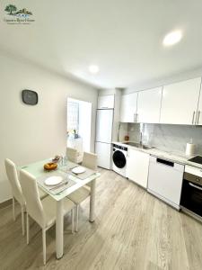a kitchen with a table and chairs in a room at Figueira River House in Bragança
