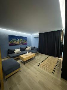 a living room with a couch and a table at 26 Villa Katerina, Elani in Elani