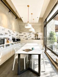 a kitchen with a white table and chairs at Mo in Houli