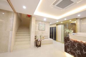 a lobby of a hotel with a staircase and a chair at Nestly Hotel in Busan +6 photos