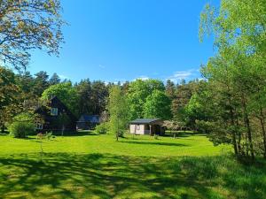 a grassy yard with a house in the background at Mežmaļi in Jūrkalne