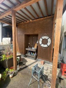 a patio with a large wooden structure with a bench at Old Sunny Garage in Tosashimizu