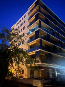 a tall apartment building at night at Louise Luxury - free parking in Nyíregyháza
