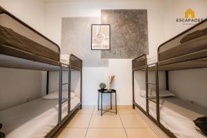 two bunk beds in a room with a side table at The Tropic@Midhill Genting (Free Wi-Fi) in Genting Highlands +54 photos