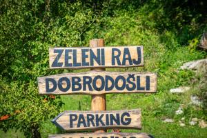 a wooden street sign with street names on it at Glamping Zeleni raj Vače in Vače