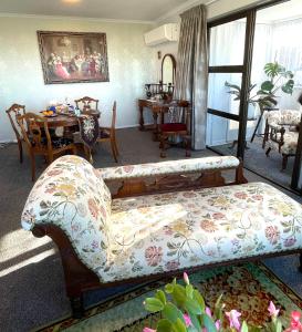 a living room with a couch and a table at The Penguins Nest in Oamaru +31 photos