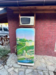 a suitcase sitting next to a brick wall with a microwave at Serce Kanyonu in Kamianets-Podilskyi