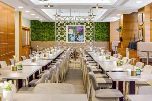 a large dining room with tables and chairs at Doubletree By Hilton London Kensington in London