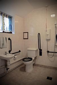 a bathroom with a toilet and a sink at Stable Cottages in Cowes +31 photos