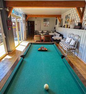 a pool table in the middle of a living room at Solayan Nature & Spa, Piscine Intérieure, Bains Nordiques & Vue Pyrénées in Couledoux