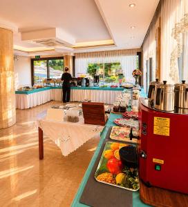 a buffet line with food on display in a restaurant at Calis Hotel in Çeşme