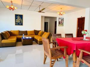 a living room with a couch and a table at Beach Star Villa Beruwala in Beruwala