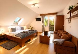 a bedroom with a bed and a couch at Safir przy samym WYCIĄGU in Karpacz