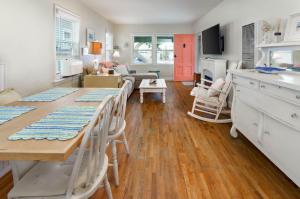 a kitchen and living room with a table and chairs at Charming Beach Bungalow in Seal Beach