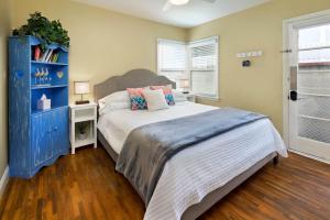 a bedroom with a large bed and a blue cabinet at Charming Beach Bungalow in Seal Beach +11 photos