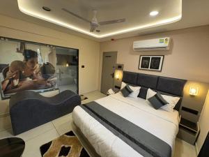 a bedroom with a large bed and a large mirror at Hotel Prominent Town in Ahmedabad +18 photos
