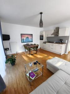 a living room with a white couch and a table at Ferienwohnung Strandparadies 7 in Juliusruh