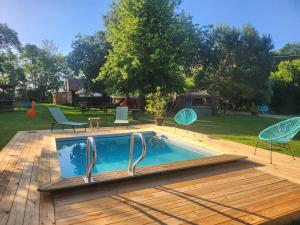 a swimming pool on a deck with chairs and a yard at Les Robinsonades in Couladère +47 photos