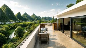 a balcony with a view of a river and mountains at The Dragons Rest Sanctuary-Yulong River Branch - Infinity Pool & Cafe - English Speaking Service - Free MTB Rental & Tailor-Made Tour Service in Yangshuo