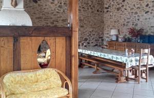 a dining room with a table and a table and a chair at Ancienne Forge Avec Piscine in Saint-Mesmin