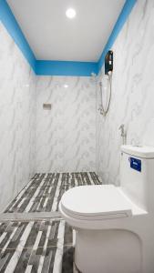 a bathroom with a white toilet in a room at Garden Hostel Koh Rong in Koh Rong Island