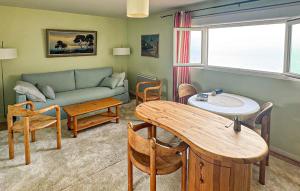 a living room with a couch and a table at Maison Vue Mer in Quiberville