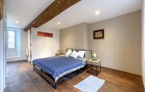 a bedroom with a bed and a wooden floor at Belle Maison À Colombages in La Baroche-sous-Lucé