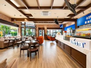 a dining room with tables and chairs in a restaurant at Norodom Clover Hotel in Phnom Penh