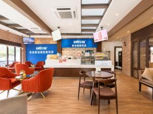 a restaurant with tables and chairs and a counter at Norodom Clover Hotel in Phnom Penh