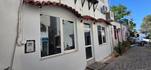 a white building with windows on a street at The comfort 2 in Raches