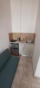 a small kitchen with a sink and a counter at The comfort 2 in Raches