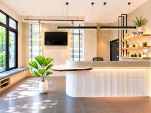 a kitchen with a counter with a potted plant at Mo in Houli