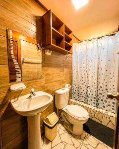 a bathroom with a sink and a toilet and a shower at Casa Lobos in Lobitos +87 photos