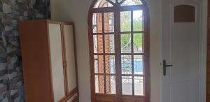a door to a room with a window and a cabinet at Eco wellness the arch in Lévktron +1 photo