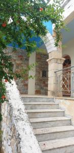 an entrance to a building with stairs and an arch at Eco wellness the arch in Lévktron