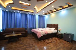 a bedroom with a bed and a couch at Greenery View Point Resort in Kathmandu +29 photos