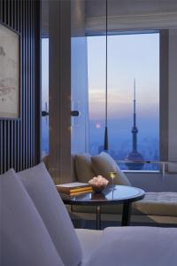 a living room with a couch and a table at Park Hyatt Shanghai in Shanghai