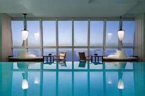 a hotel room with a pool with chairs and a window at Park Hyatt Shanghai in Shanghai