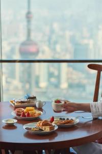 a table with plates of food on it at Park Hyatt Shanghai in Shanghai