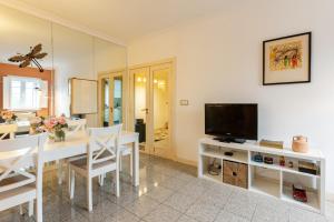 a dining room with a white table and a television at Casa do Rio in Chaves