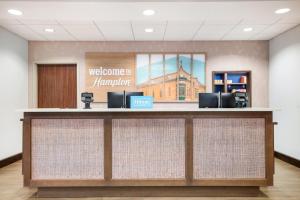 a welcome counter in a lobby with a welcome sign at Hampton Inn Uvalde in Uvalde +32 photos